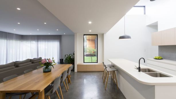 The kitchen and the living room is the central piece of the home and is where the indoor-outdoor connection is most prominent, with the kitchen featuring a pop-up roof element. Photo: LightStudies