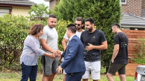 Selling agent Paul Tassone of Professionals Ermington congratulates the winning bidders and their family and friends after the auction. Photo: Peter Rae.
