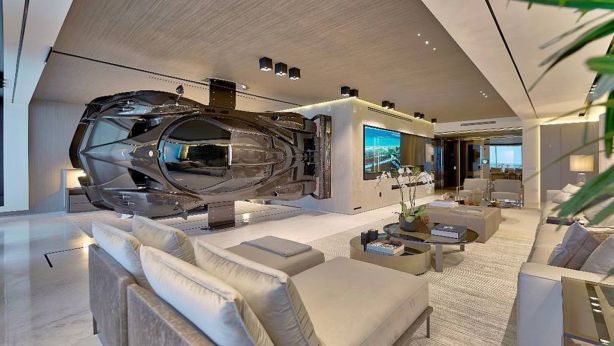 The car as art - mounted sideways, this $2.1m Pagani Zonda R sportscar forms a partition between the master suite and living room in this high-end Miami condo. Photo: Finish My Condo