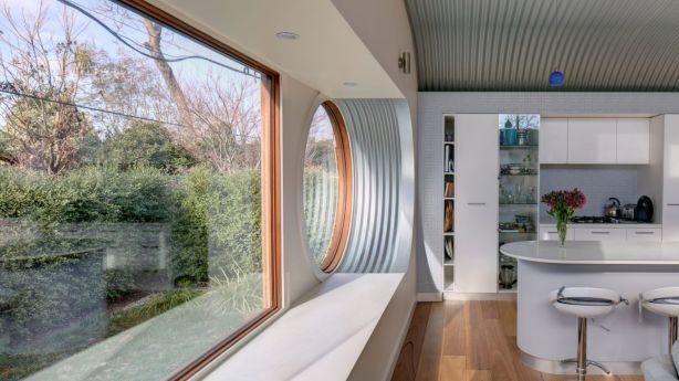 The extension showcases a consistent harmony of flooring, joinery and lighting. Photo: Brett Boardman