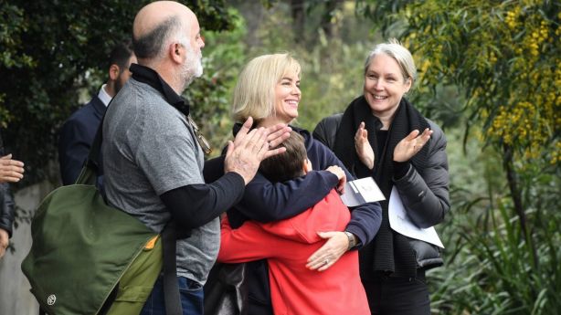 Successful buyer Jennifer Wayne, pictured hugging her 10-year-old son Jen, couldn't wipe the smile from her face after snapping up a Tempe house at auction. Photo: Peter Rae.