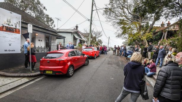 About 50 people gathered in the cul-de-sac to watch the property go under the hammer. Photo: Peter Rae.