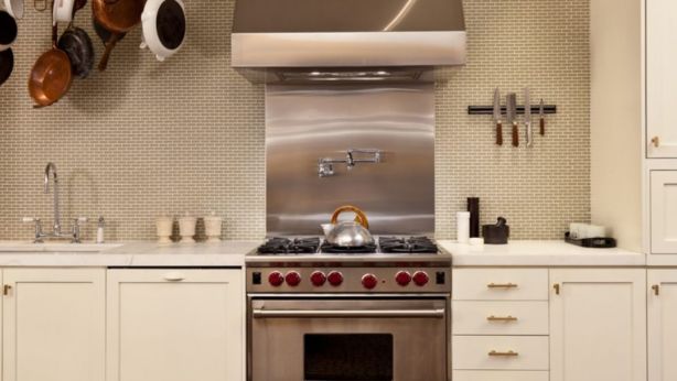 The kitchen features include Pietra Cucina marble benches, hand-painted cabinets and a 6-burner Wolf range. Photo: Snowden Jones