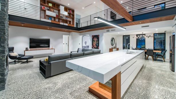 The home has an industrial open-plan with a void over two storeys. Photo: Master Builders ACT