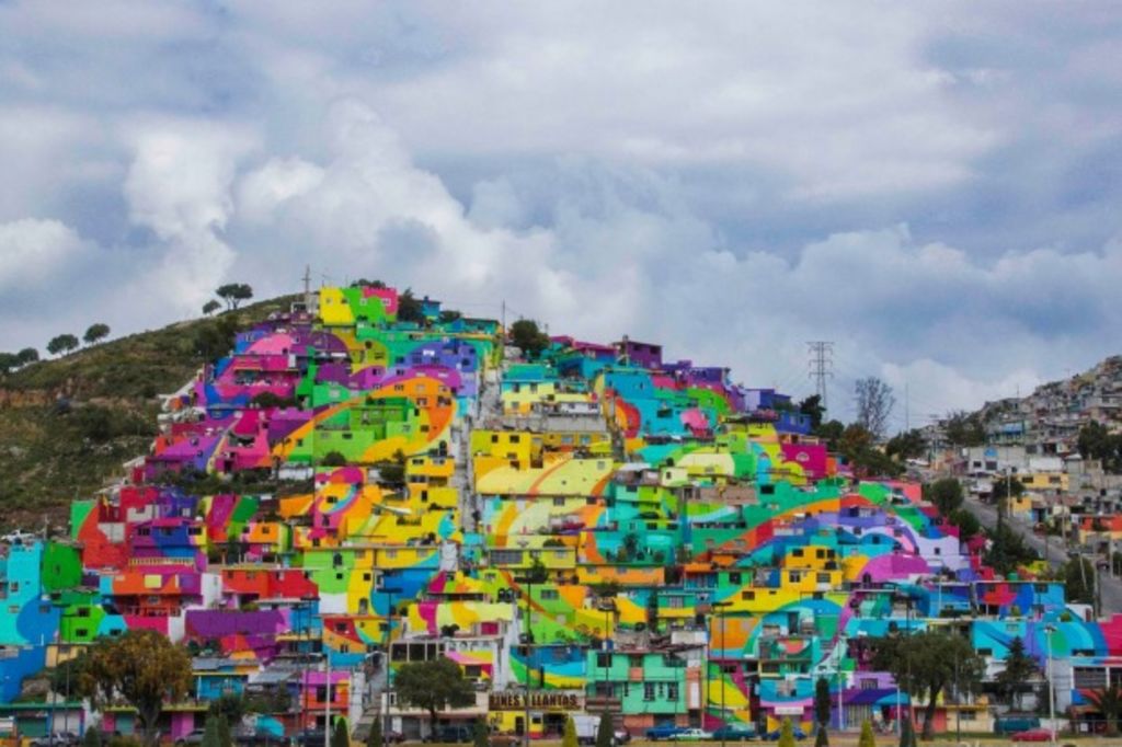 Artists bring colour into a community by painting all 209 houses in the neighbourhood