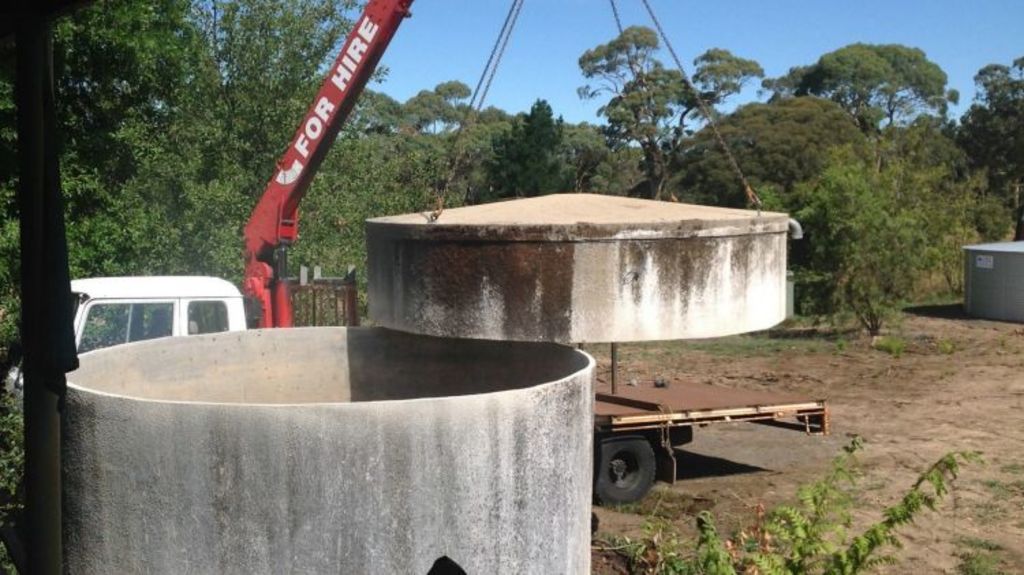 Step one: Lifting the lid from the tank. Photo: Supplied