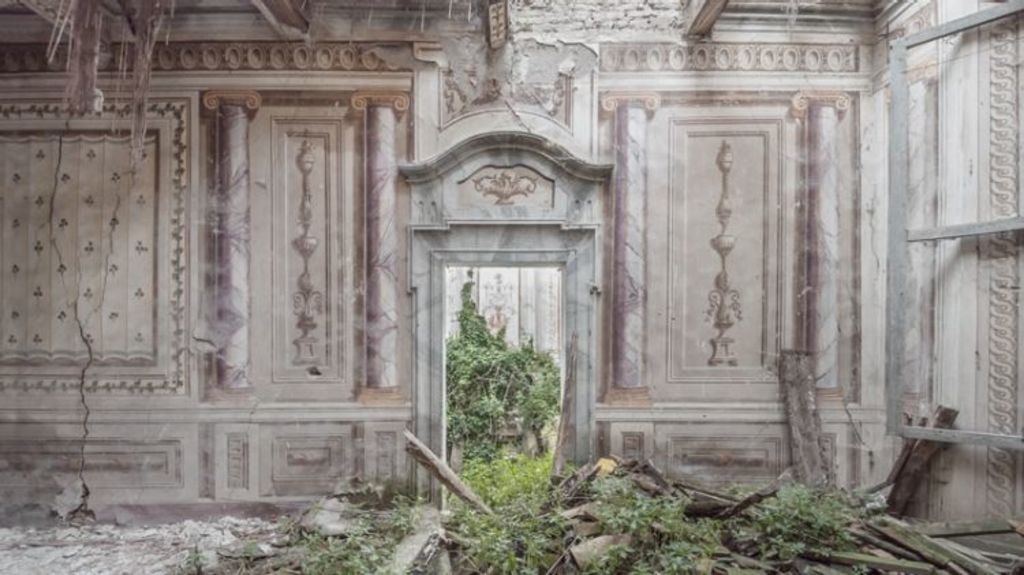 The crumbling walls and faded frescoes in the rooms of the villa contrast with the twisting roots and vegetation. Photo: Mirna Pavlovic