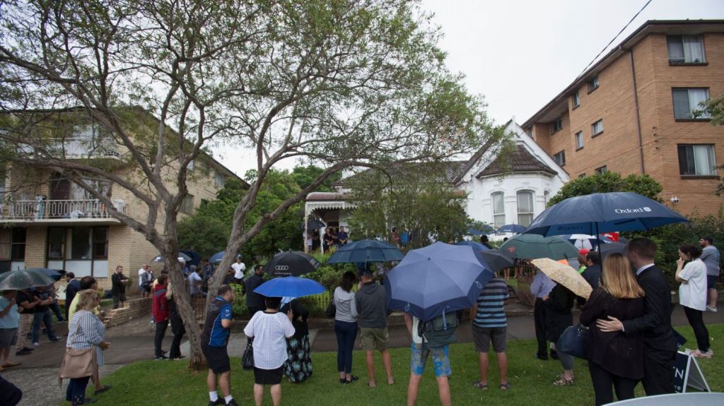 A large crowd braved the rain for the auction of the Marrickville home which has been held by the one family for more than 90 years. Photo: Fiona Morris
