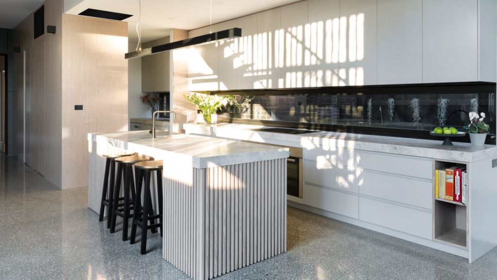 A showpiece of this family home in Northcote is the expansive, naturally lit kitchen, dining and family area. Photo: Jellis Craig