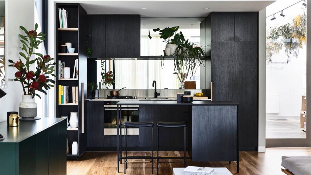The Brunswick kitchen by Neometro utilises illusions of space – from the mirrored splashback to the grey colour palette. Photo: Neometro