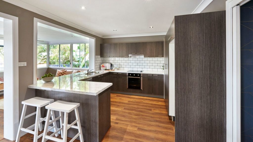 After: To revive this kitchen, appliances, a bench top and a tiled splashback were installed. Photo: Cherie Barber