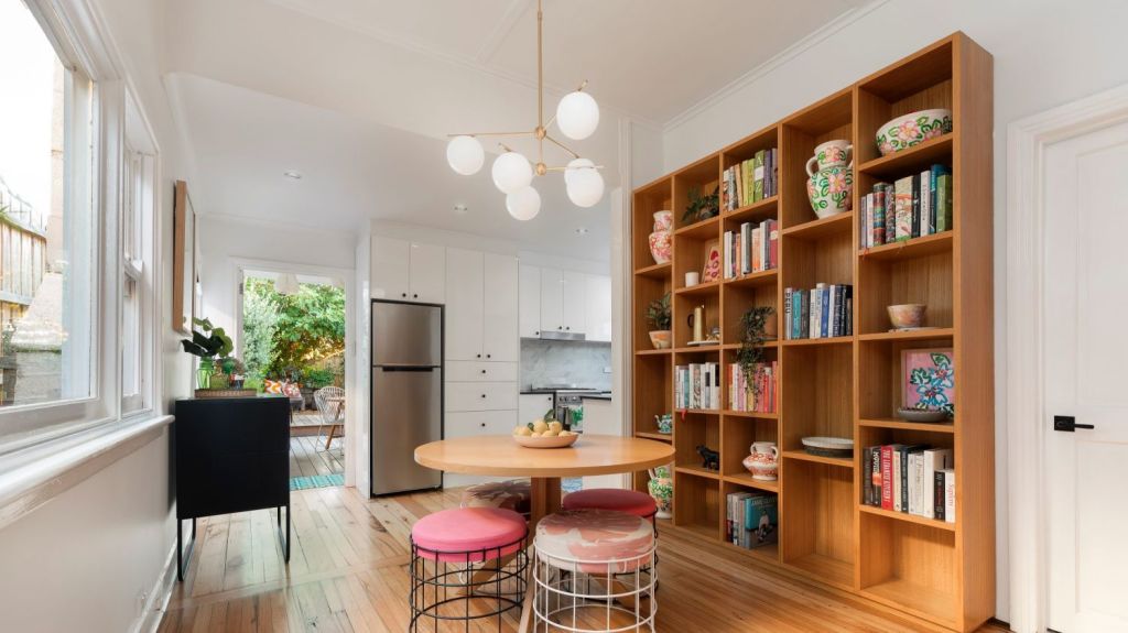 Expanses of glossy floors and a subway-tiled bathroom add contemporary pizzazz to an update that has respected the home's era. Photo: Nelson Alexander