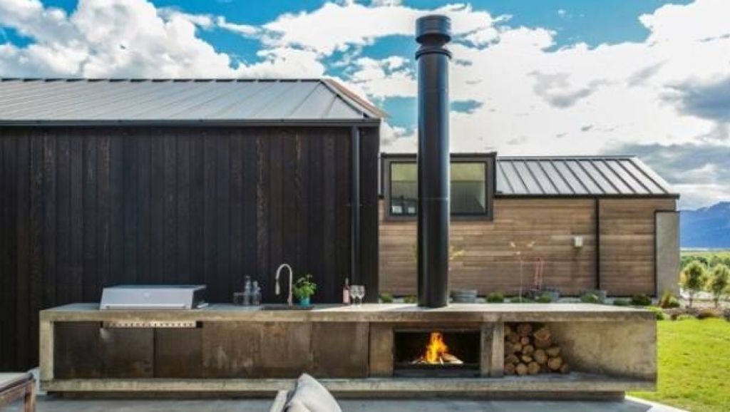 An Escea outdoor cooking fire completes this outdoor kitchen by Dravitzki Brown Architecture, it comes with an adjustable cooking plate for flame grilling. Photo: Escea
