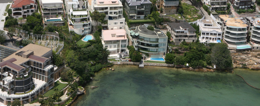 The distinctive curved facade of Steve Harker's Point Piper waterfront home (two to the left of Aussie John Symond's mansion).