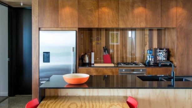 A sheet of glass over timber for your splashback gives warmth and is easier to clean than tiles. Photo: Sophie Heyworth