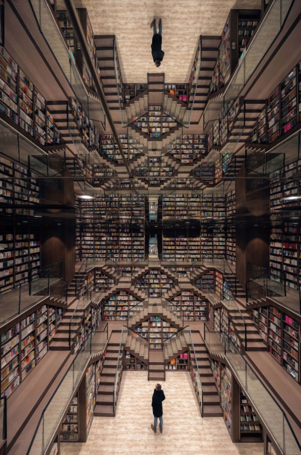 Mirrored ceilings add to the visual drama of the main hall within the bookstore.