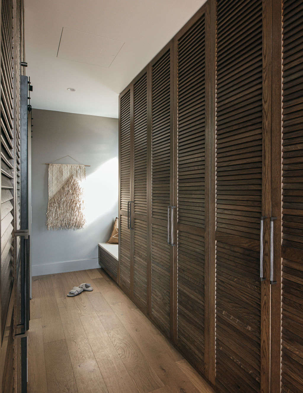 The walk-in wardrobe in House Two features aged American oak. Photo: Grace Picot