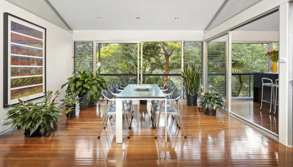 The tall ceilings and high-level windows allow for the natural surrounds to seep into every corner of the home. Photo: Supplied