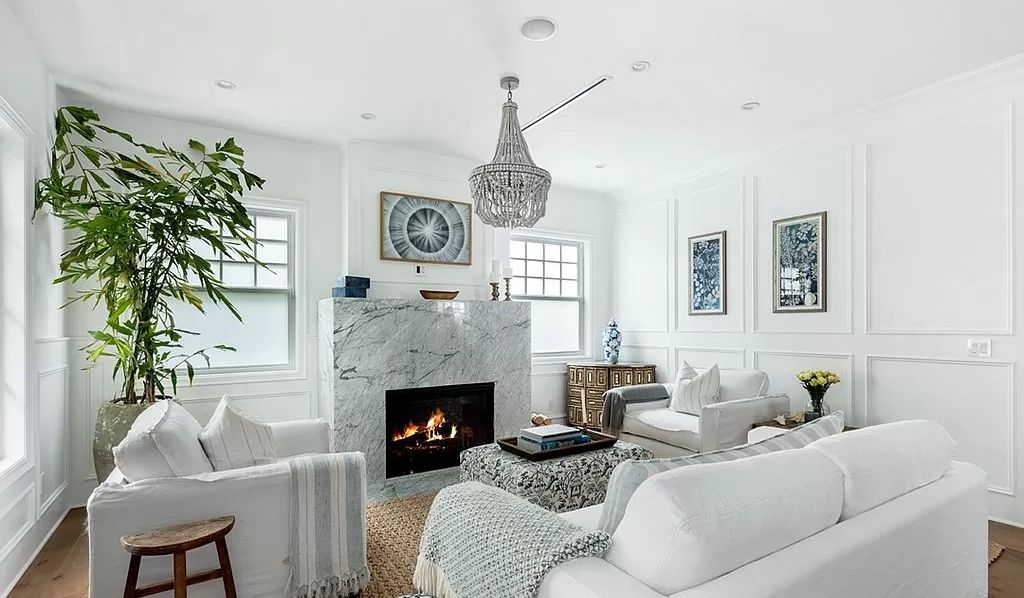 The home features several fireplaces and has high ceilings and hardwood floors throughout. Photo: Zillow