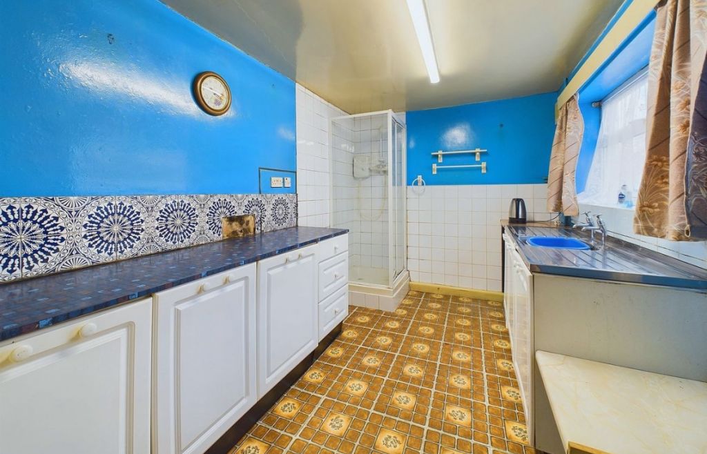 A shower cubicle is located in the kitchen of a three-bedroom home for sale. Photo: JDG Sales & Lettings