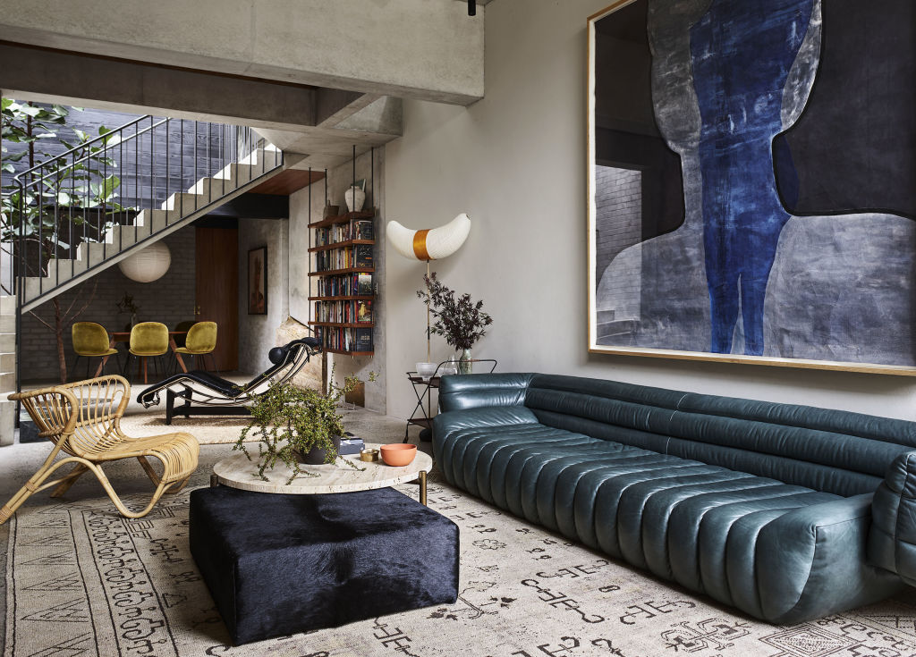 The living room features Tasmanian blackwood shelving and polished concrete flooring. Photo: Supplied