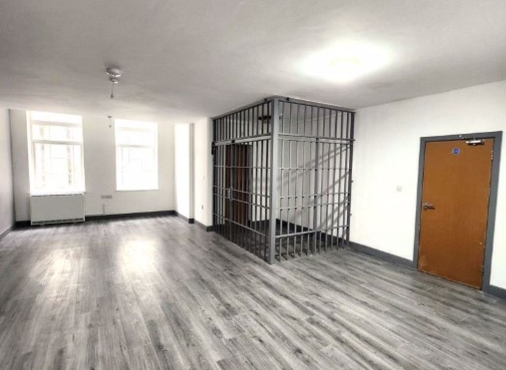 Studio apartment for rent in England has a jail cell in the living room. Photo: Taylors Estate Agents