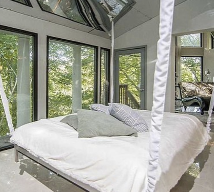 This home has a bed suspended from the ceiling. Photo: Zillow.com