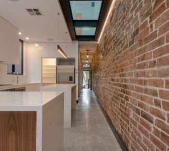 A glass floor on an upper level combines with skylights to bring light into this Bondi terrace.