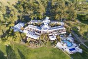 Iconic Scenic Rim golf resort partially sold, remainder on market for $100m – polo fields, school included
