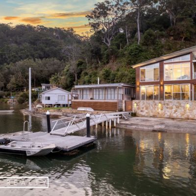 Secluded waterside property listed for sale, boat included