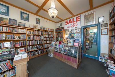 Carlton North bookstore with a unit on top sells at least $390,000 above reserve