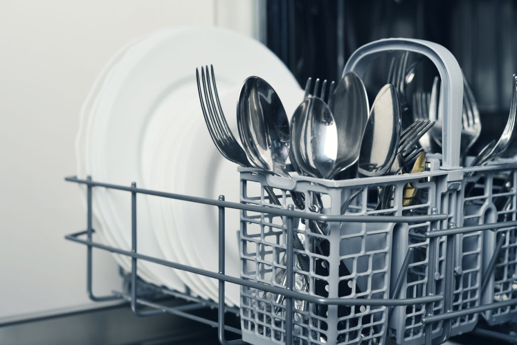 Should you load knives and forks up or down in the dishwasher? Photo: iStock