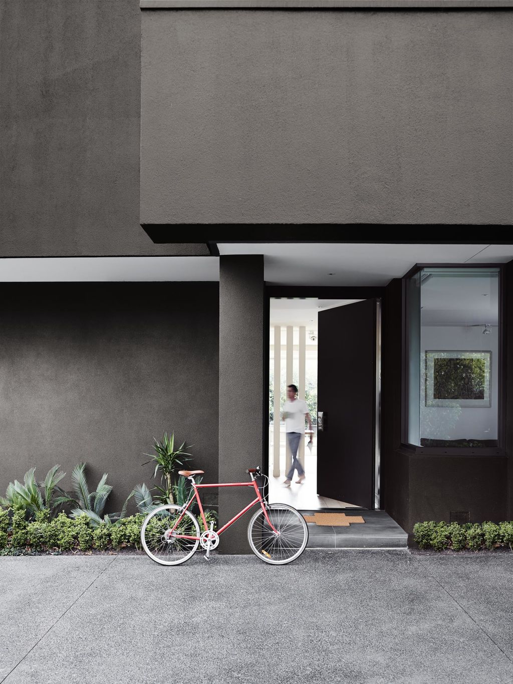 A darker colour palette helps a home recede into its natural surroundings. Photo: Dulux Photo: Dulux