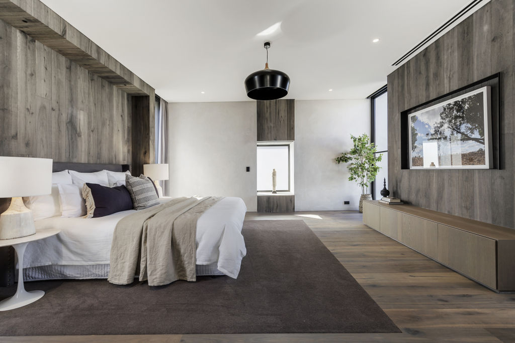The timber-clad main bedroom is of a grand scale. Photo: Supplied
