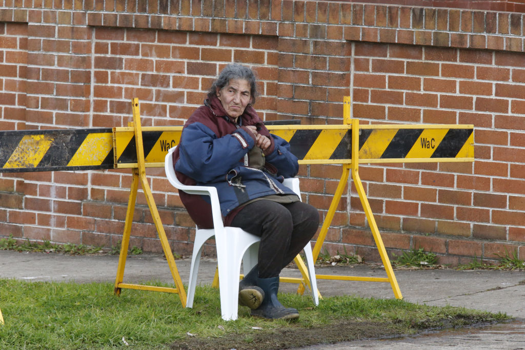Mary Bobolas watches on as Waverley Council clears junk from outside her house in 2015. Photo: Peter Rae Photo: Peter Rae