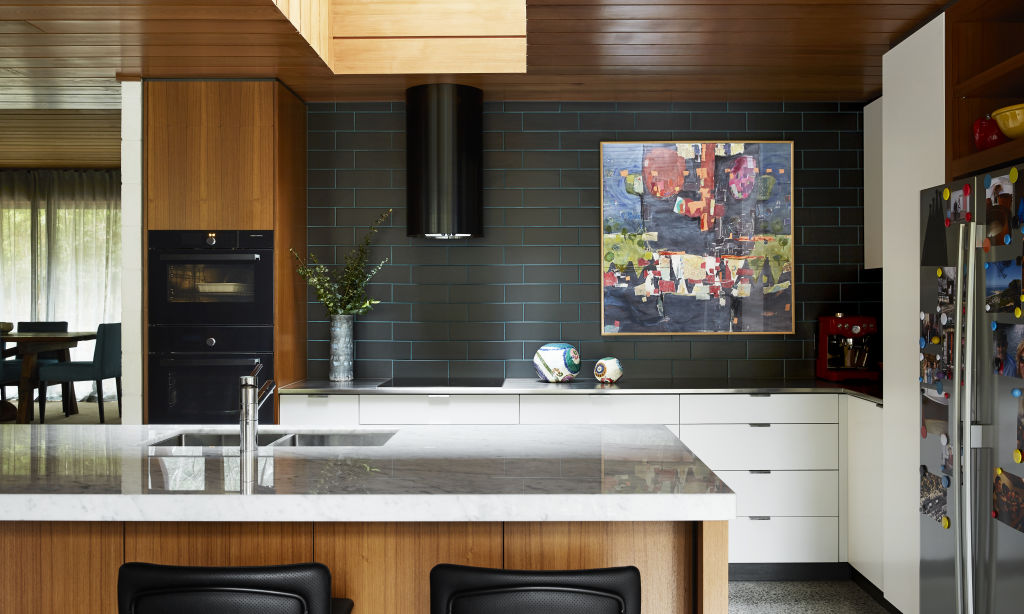 Statement charcoal tiles with turquoise grout in the kitchen. Photo: Caitlin Mills