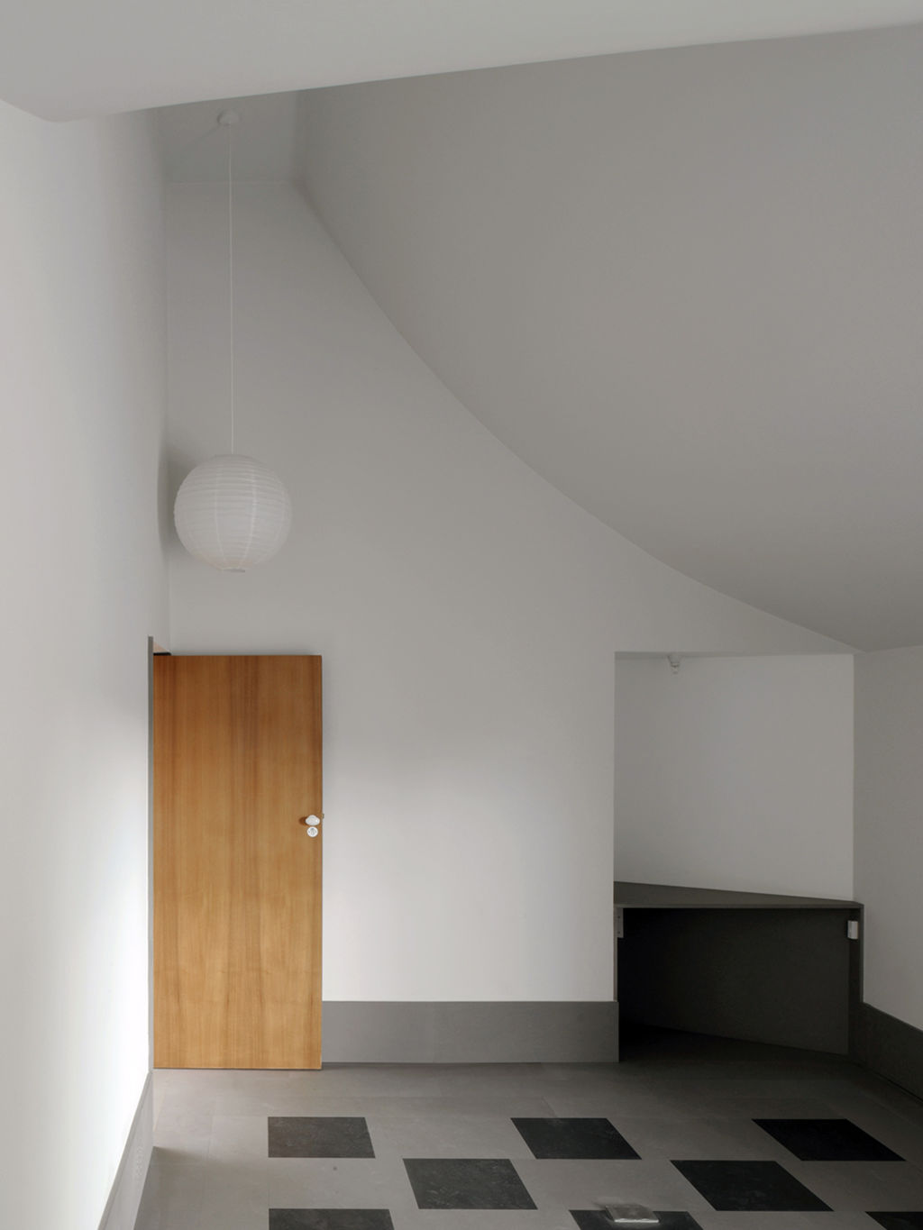 Ceilings in the bedrooms on the upper level follow the lines of the roof. Photo: David Leech