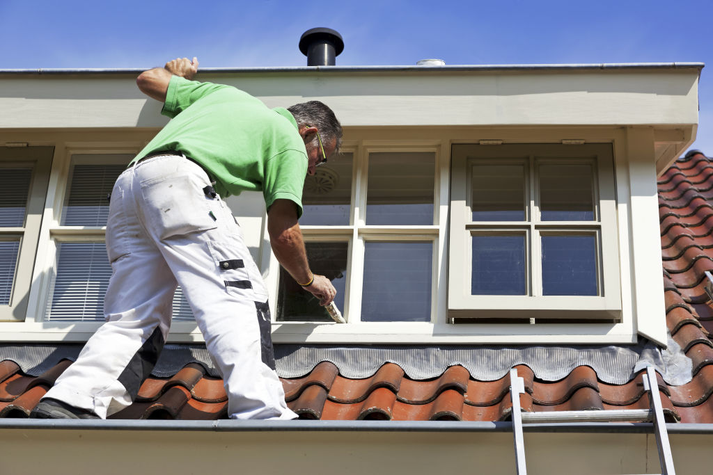 The ladder should have at least four rungs about the stepping point on the roof. Photo: iStock.