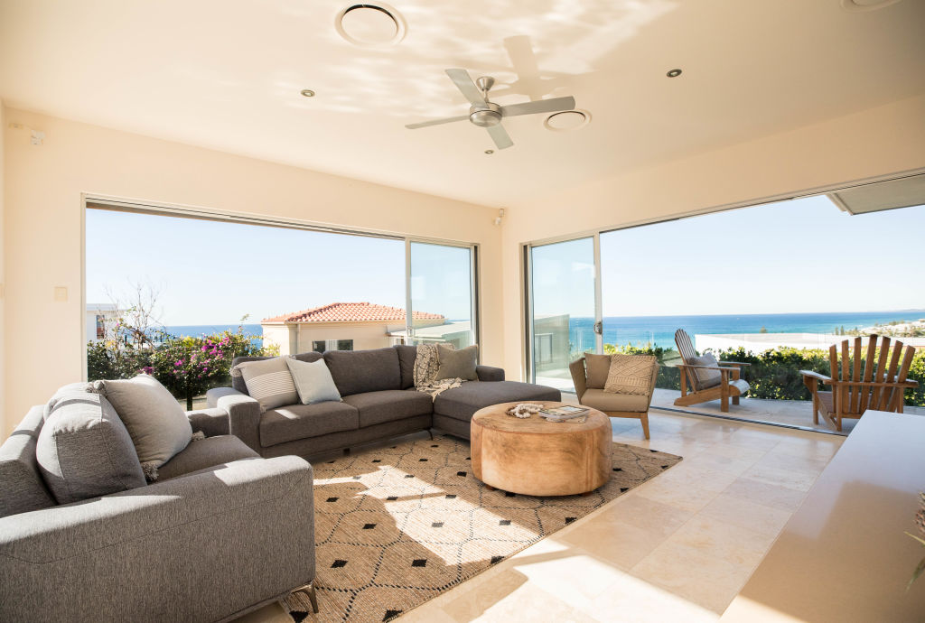 The open-plan living area flows out to a courtyard and pool. Photo: Supplied