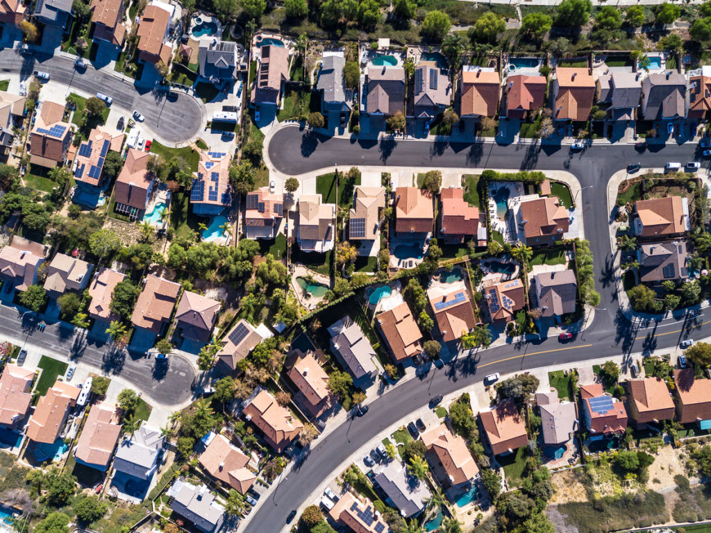 Top down aerial shot of suburban tract housing near Santa Clarita, California. A maze of roads and dead end streets of large single family homes, some with swimming pool.