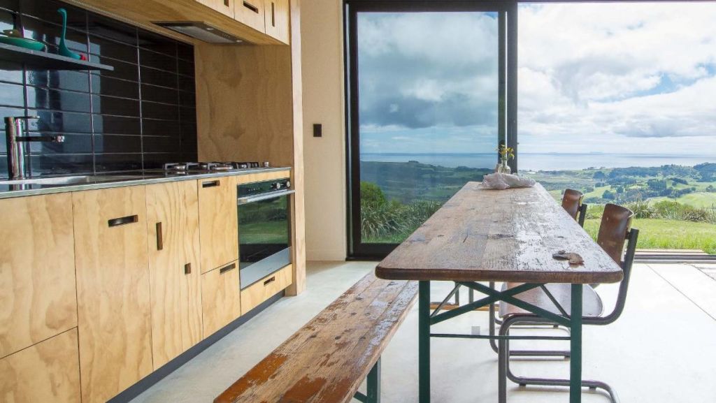 Where space is at a premium, why not ditch the kitchen island and return to the farmhouse table. Photo: Sophie Heyworth