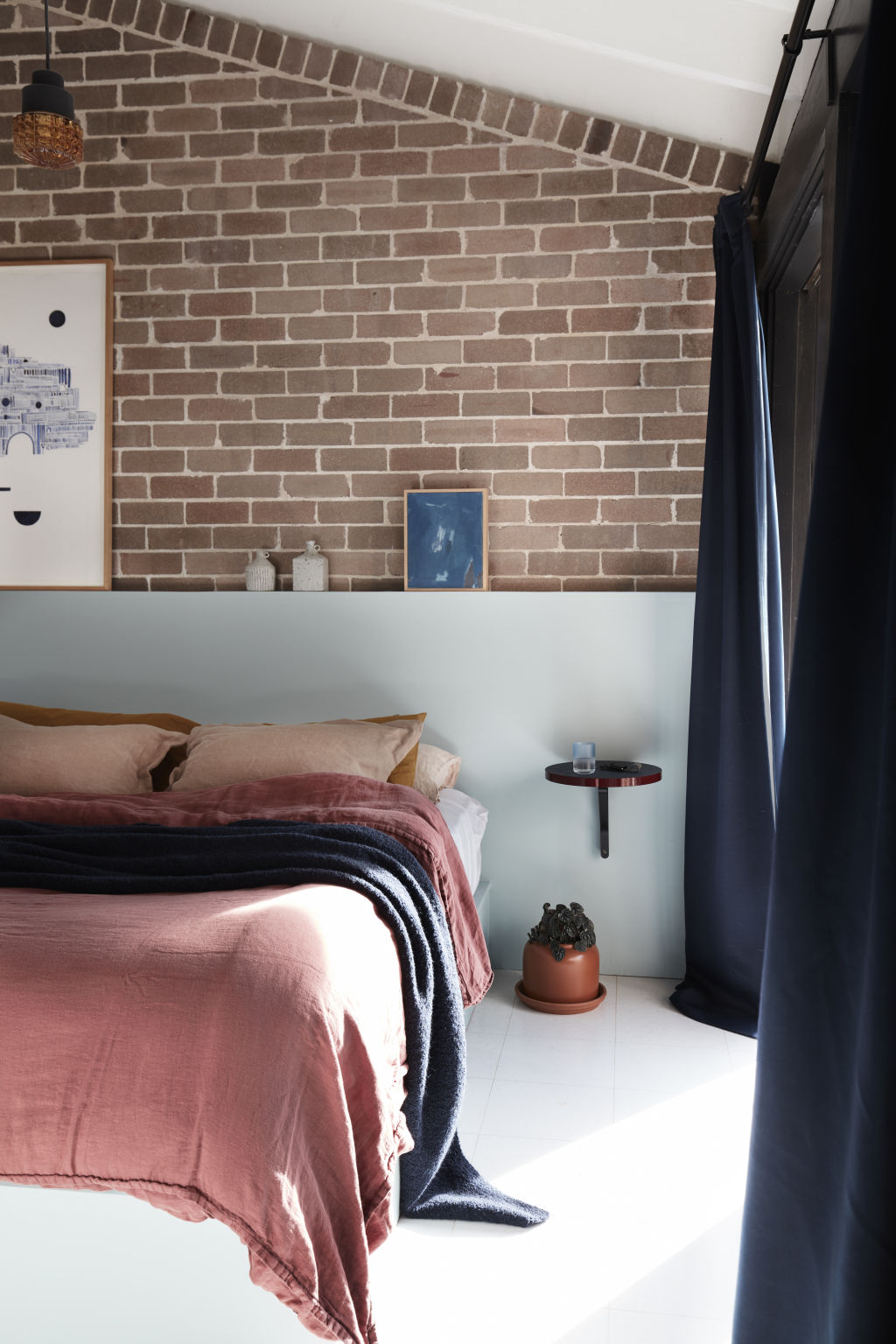 Exposed brick adds a raw textural element in this bedroom. Photo: Prue Ruscoe