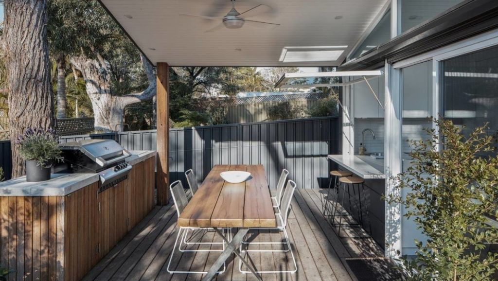 The kitchen opens out to a covered outdoor room, complete with built-in barbecue. Photo: Andy MacPherson