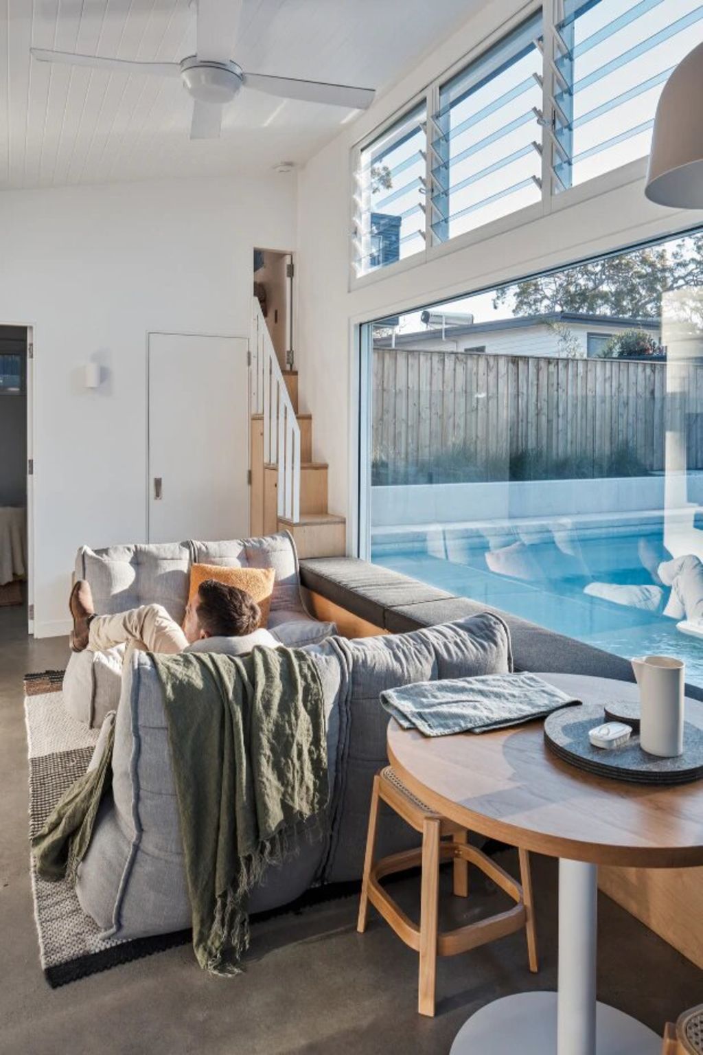 High windows let in plenty of light, as does the glazed wall looking out to the pool. Photo: Andy MacPherson