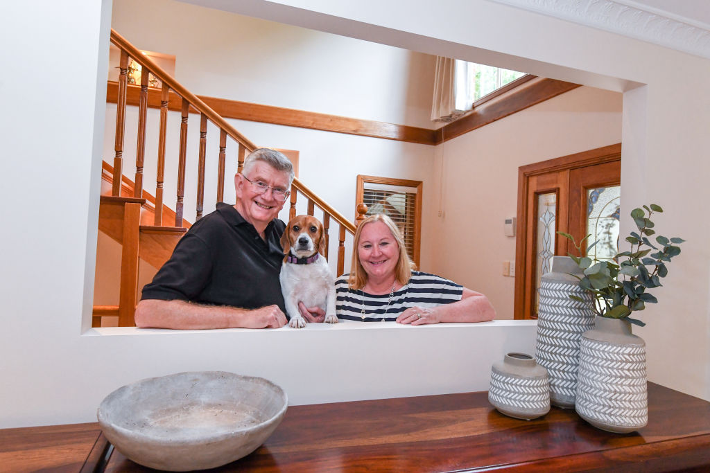 Norm and Sandra Cahill, with dog Bindie, in their Epping home which they’ve had on the market since October.  Photo: Peter Rae