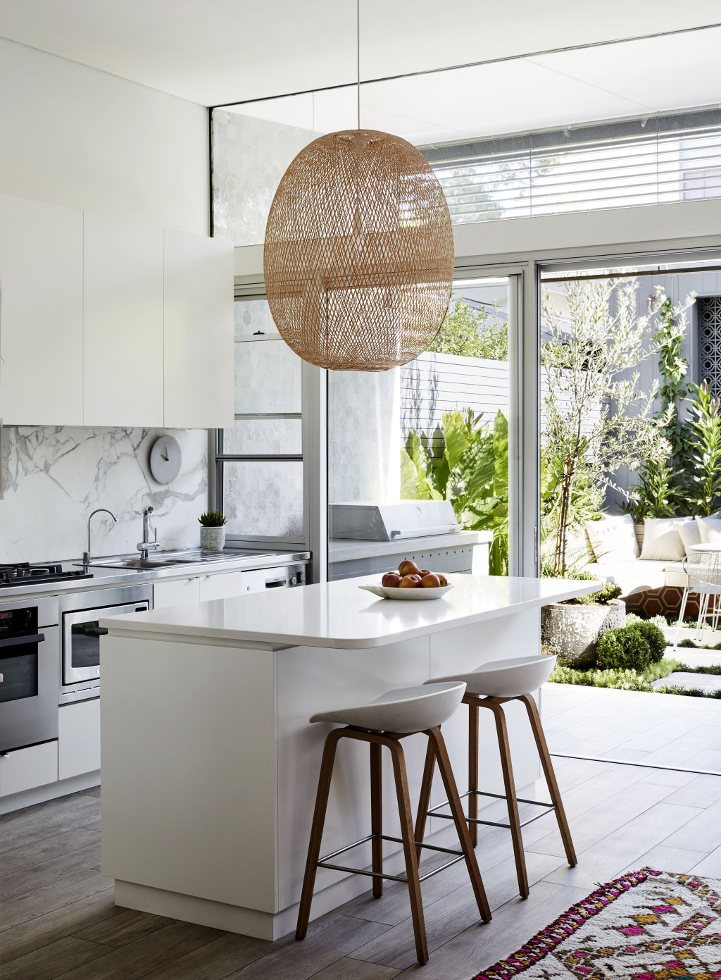 The kitchen looking out to the lush courtyard. Photo: Caitlin Mills Styling: Annie Portelli