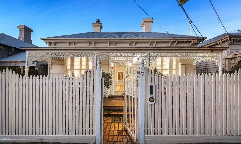 This elegant timber cottage featured manicured gardens.