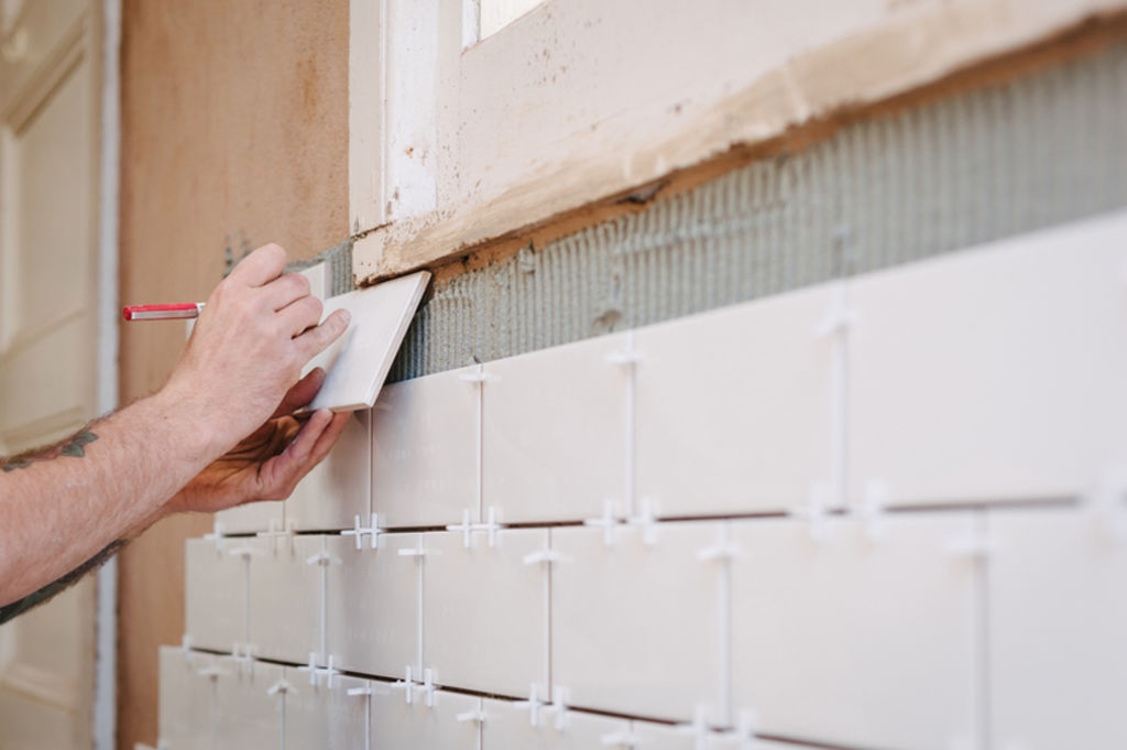 Home repairs that handymen can perform can range from replacing a few fence palings to re-grouting tiles in the bathroom. Photo: Stocksy