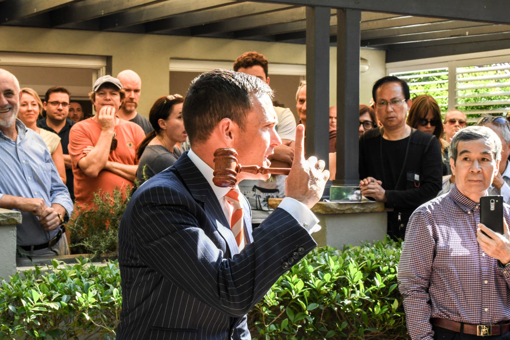 Auctioneer Damien Cooley has been seeing boom-time bidding tactics again.  Photo: Peter Rae