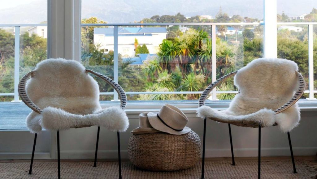 Two vintage chairs benefit from the sheepskin treatment. Photo: Jane Ussher